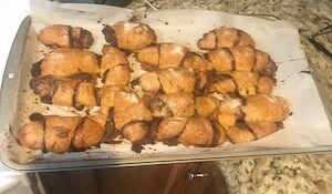 nutella rugelach on a baking sheet on a marble countertop